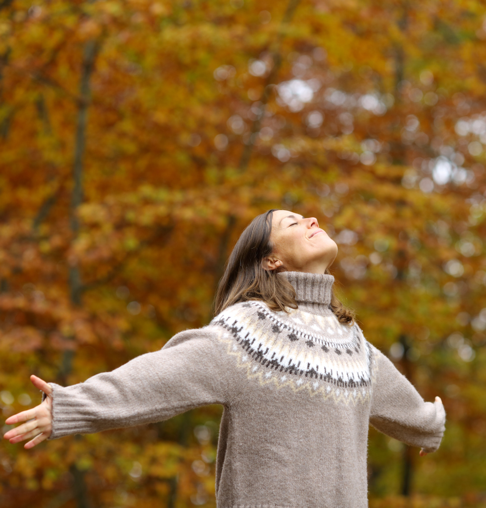 Middle age woman stretching arms breathing fresh air in a forest in autumn Middle age woman stretching arms breathing fresh air in a forest in autumn